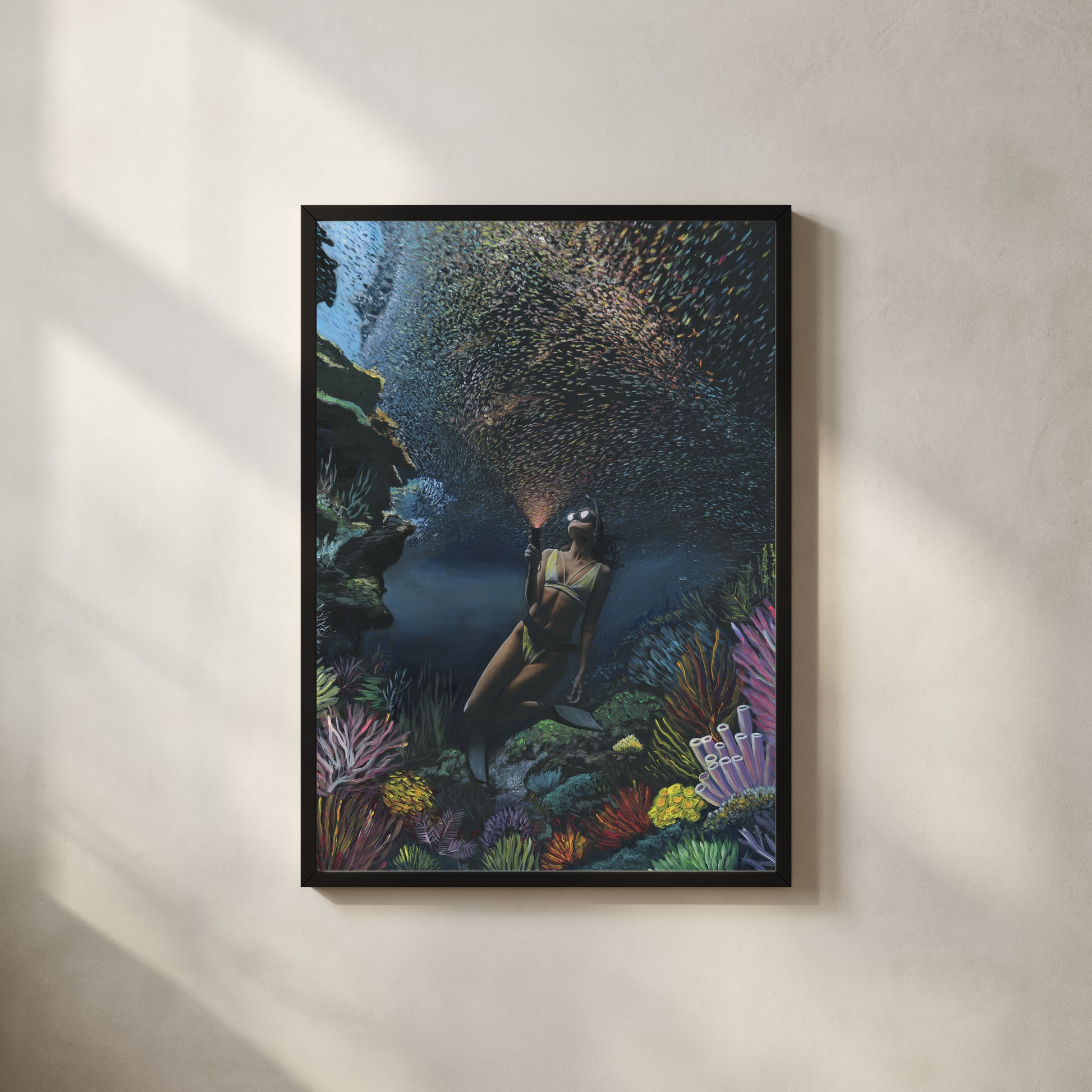 Underwater diver surrounded by coral and fish — collaboration by Carlos V. Garcia and Dan Legend, Cayman Islands.