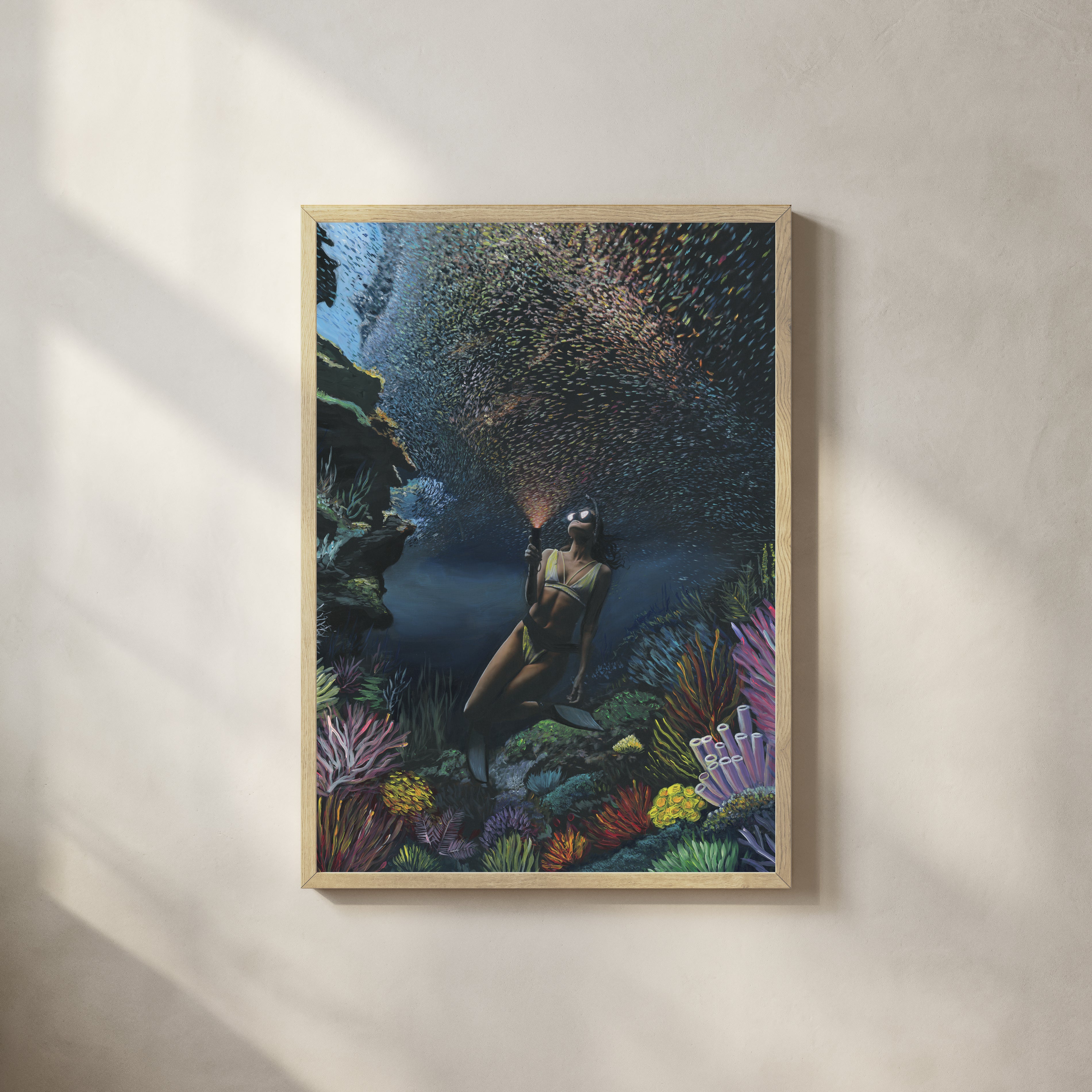 Underwater diver surrounded by coral and fish — collaboration by Carlos V. Garcia and Dan Legend, Cayman Islands.